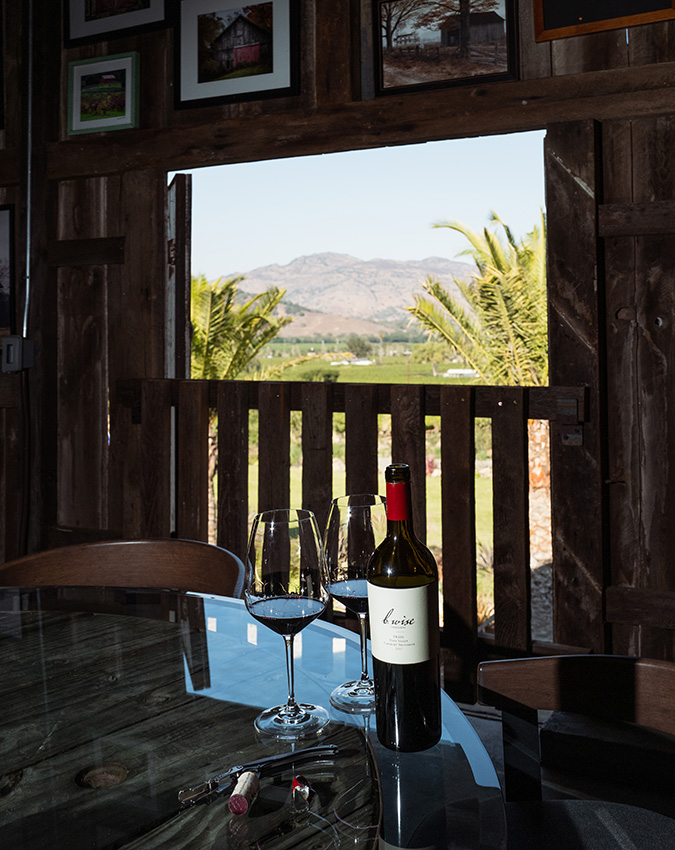 Bottle of wine on a table at The Loft with a view in the background