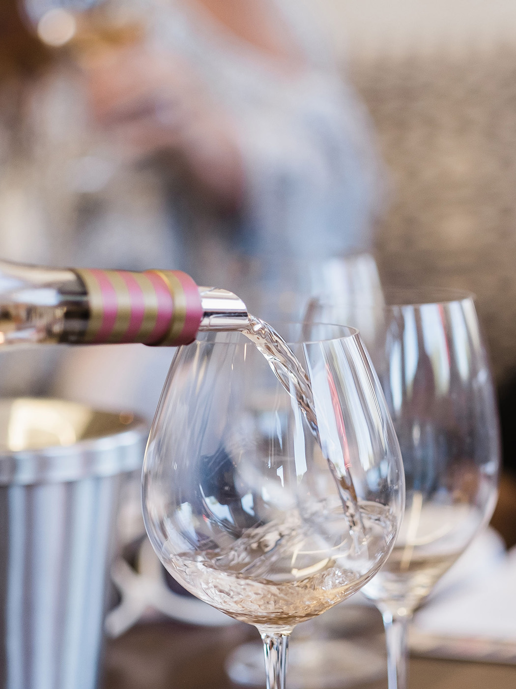 White wine being poured into glasses