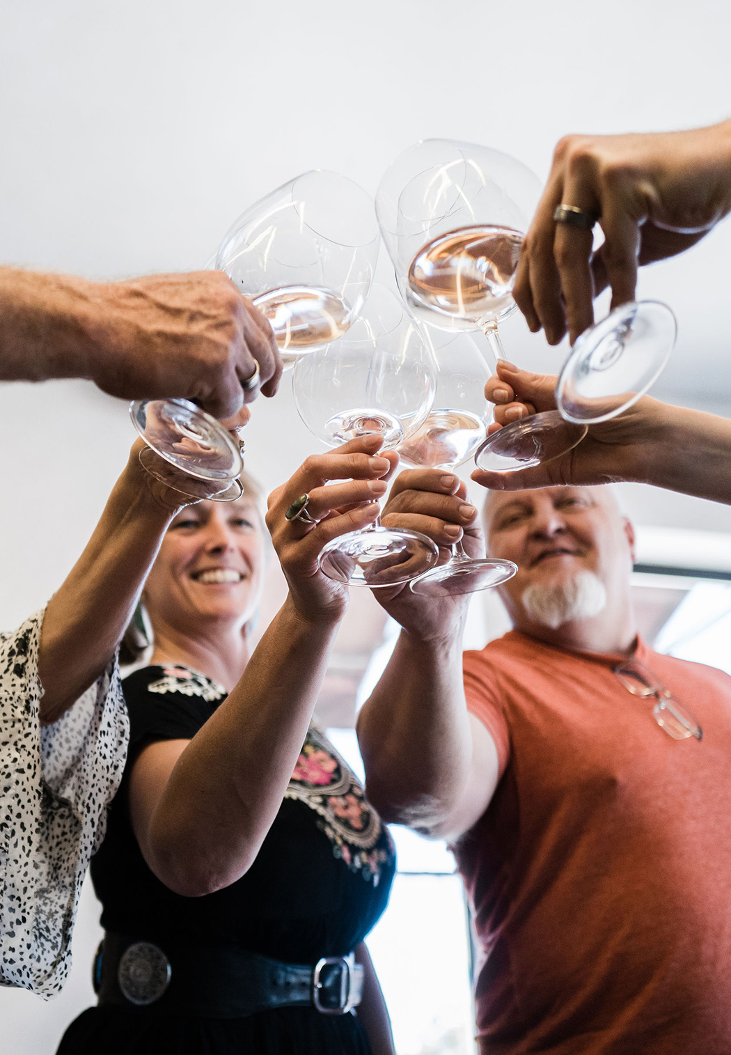 People cheering with white wine glasses at Kenwood Tasting Lounge