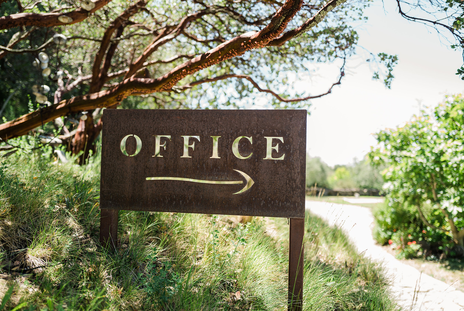 Office sign on side of trail