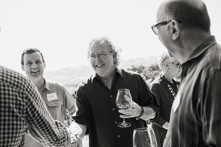 B. Wise Vineyards proprietor Brion Wise greets club members at a harvest party