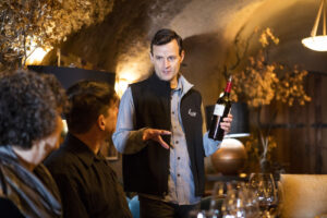 B. Wise General Manager and Sommelier Colin Heinrich with guests in the B. Wise Estate Cave