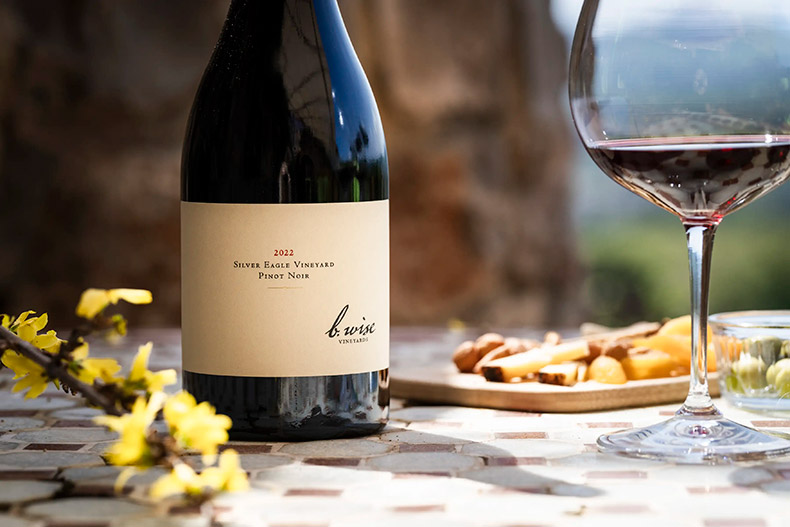 b. wise club bottle of wine and glass on the table