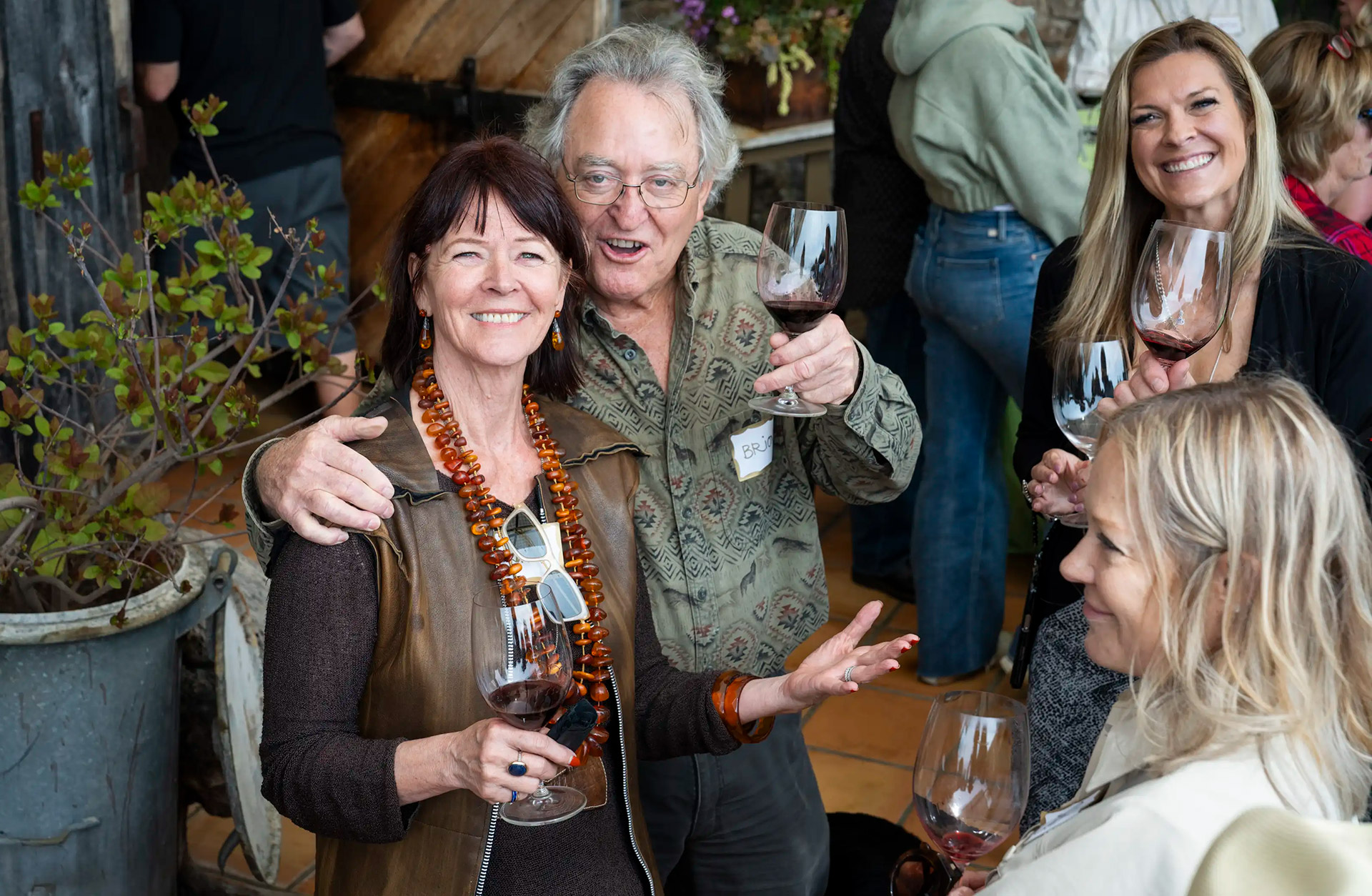 b. wise club members enjoying a glass of wine on the patio with friends
